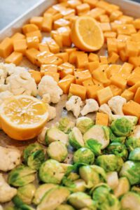 Fall Cous Cous 1 butternut squash, brussel sprouts, cauliflower and lemon on a baking sheet