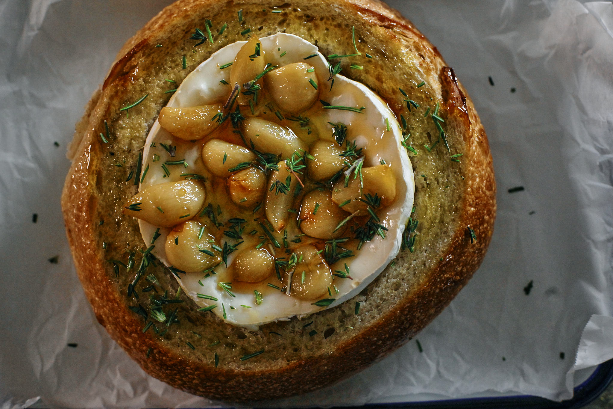 sourdough bread filled with cranberry sauce, garlic confit, brie cheese, honey and herbs.