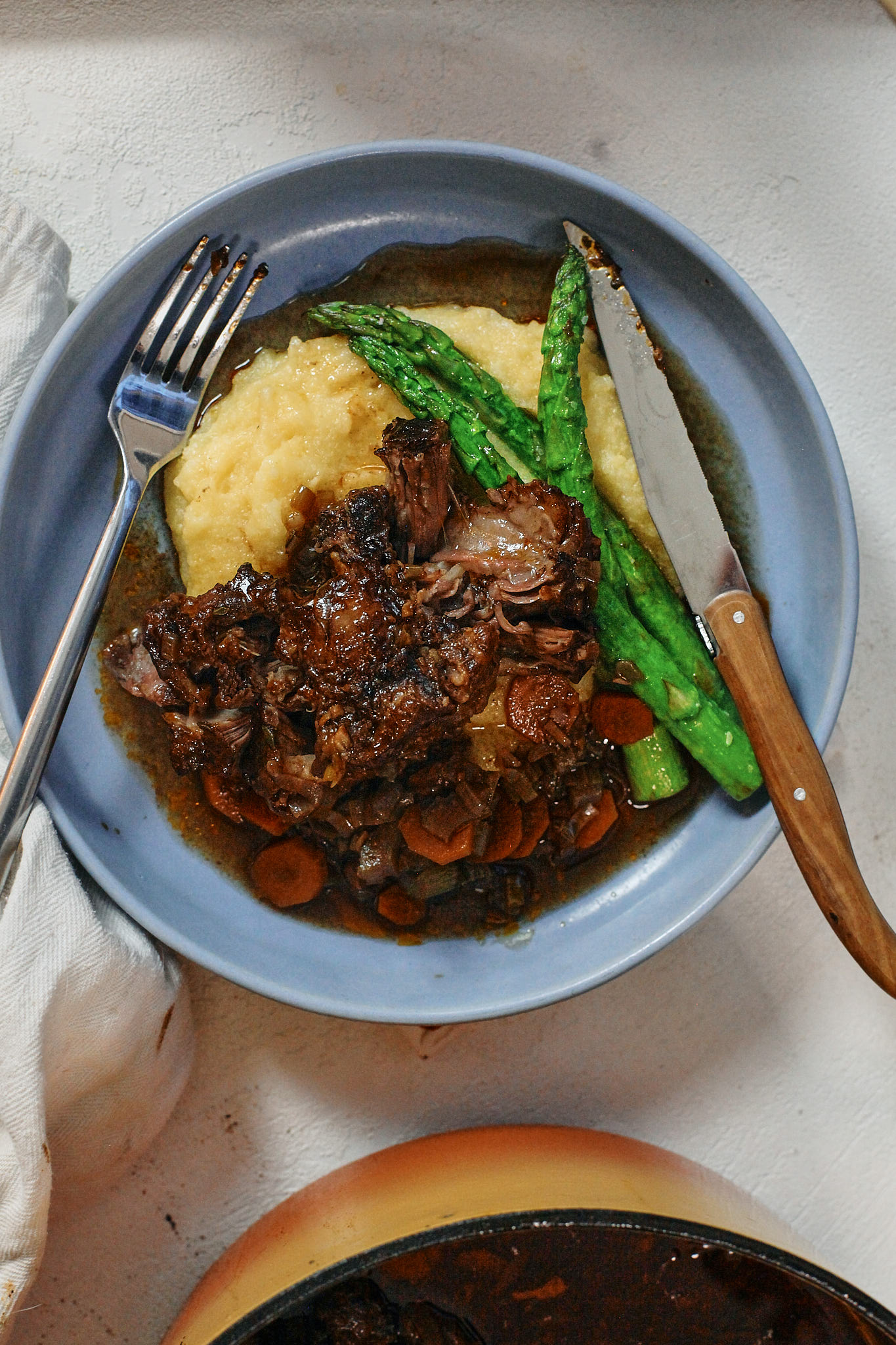 braised oxtail over a bed of polenta with asparagus
