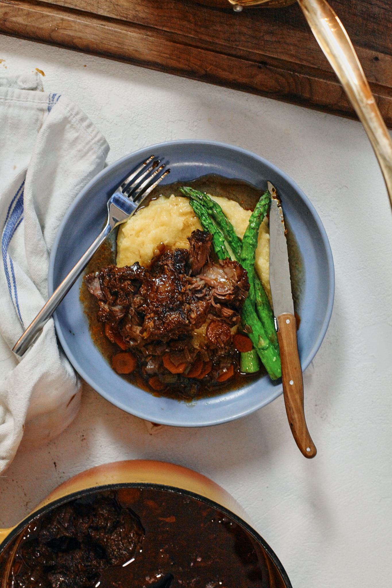 braised oxtail over polenta with asparagus
