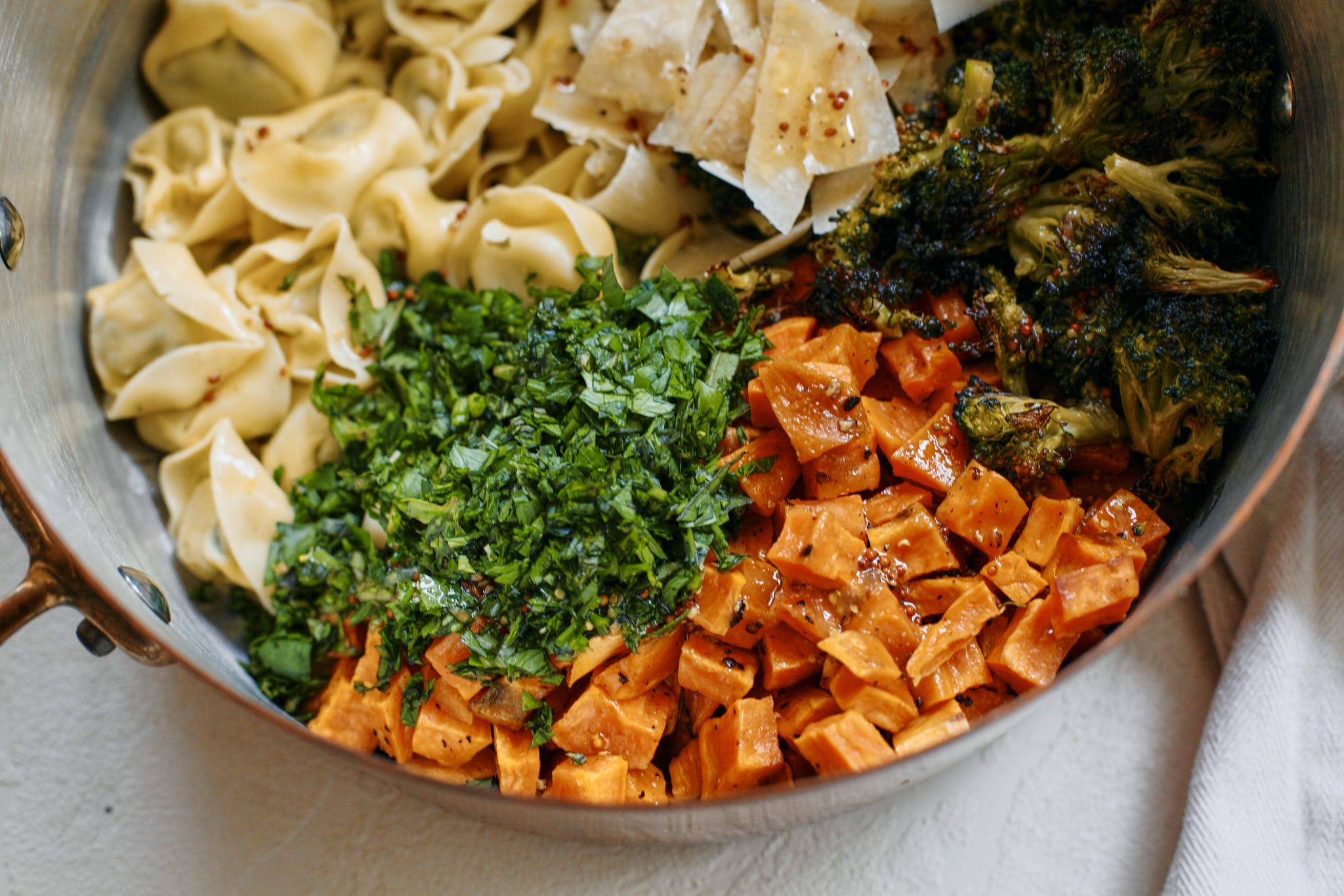 assembling the warm rustic tortellini bowl