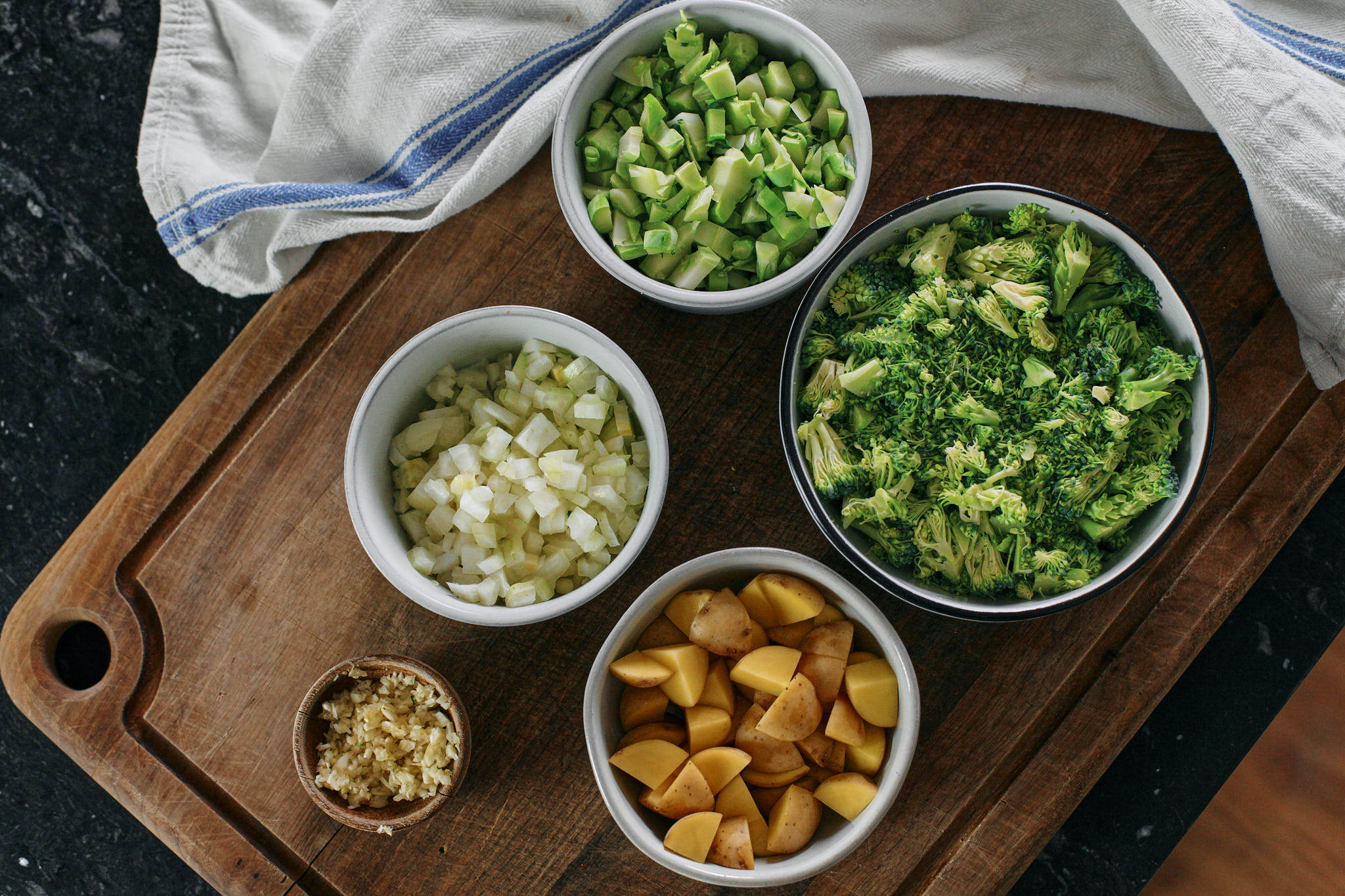 prep for broccoli cheddar soup with shells - chopped broccoli, onion, potato, garlic