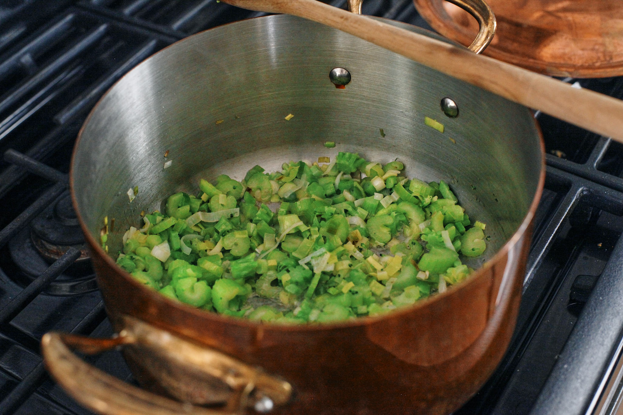 green goddess tortellini soup 1 greens sautΓ©eing in the pot