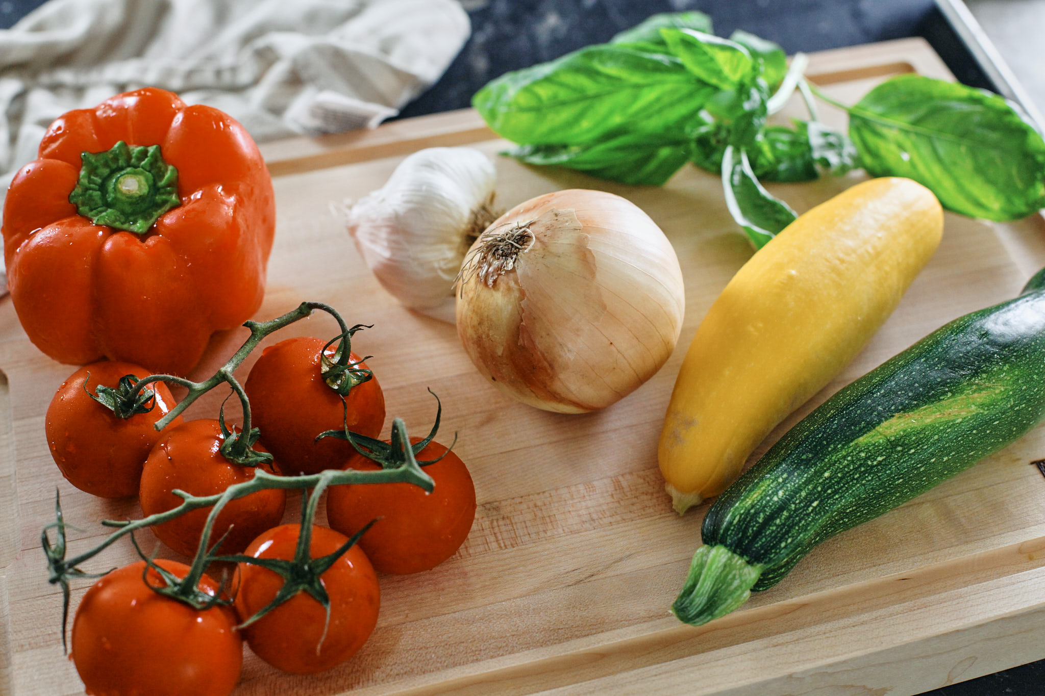 tomatoes, bell pepper, garlic, onion, basil, and zucchini