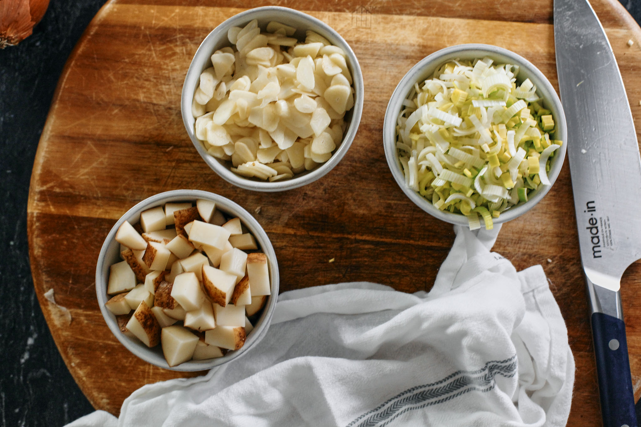 Mighty Greens Garlic Soup prep for the mighty greens garlic soup - chopped potato, sliced garlic, and chopped leek.