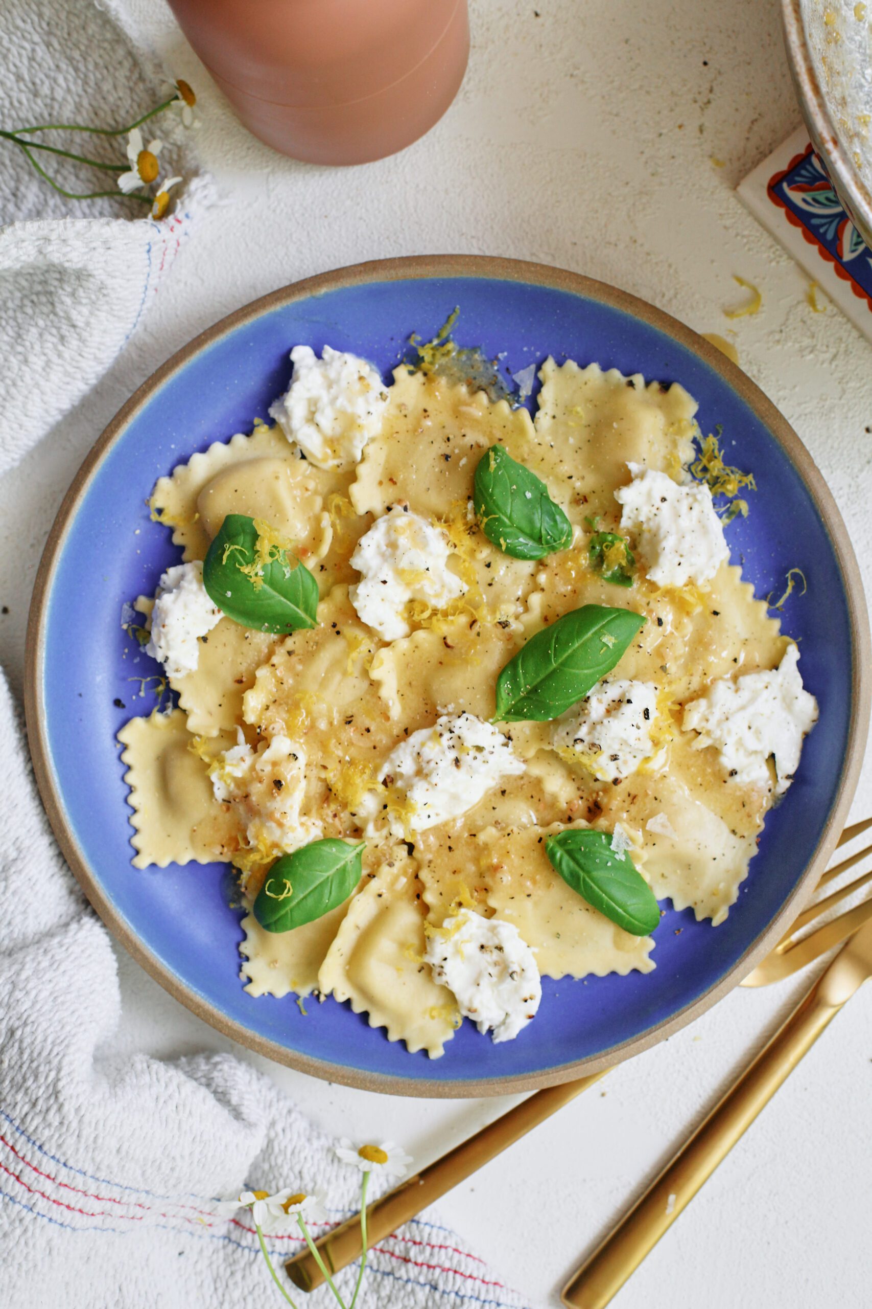 burrata & lemon ravioli, plated with basil and lemon zest