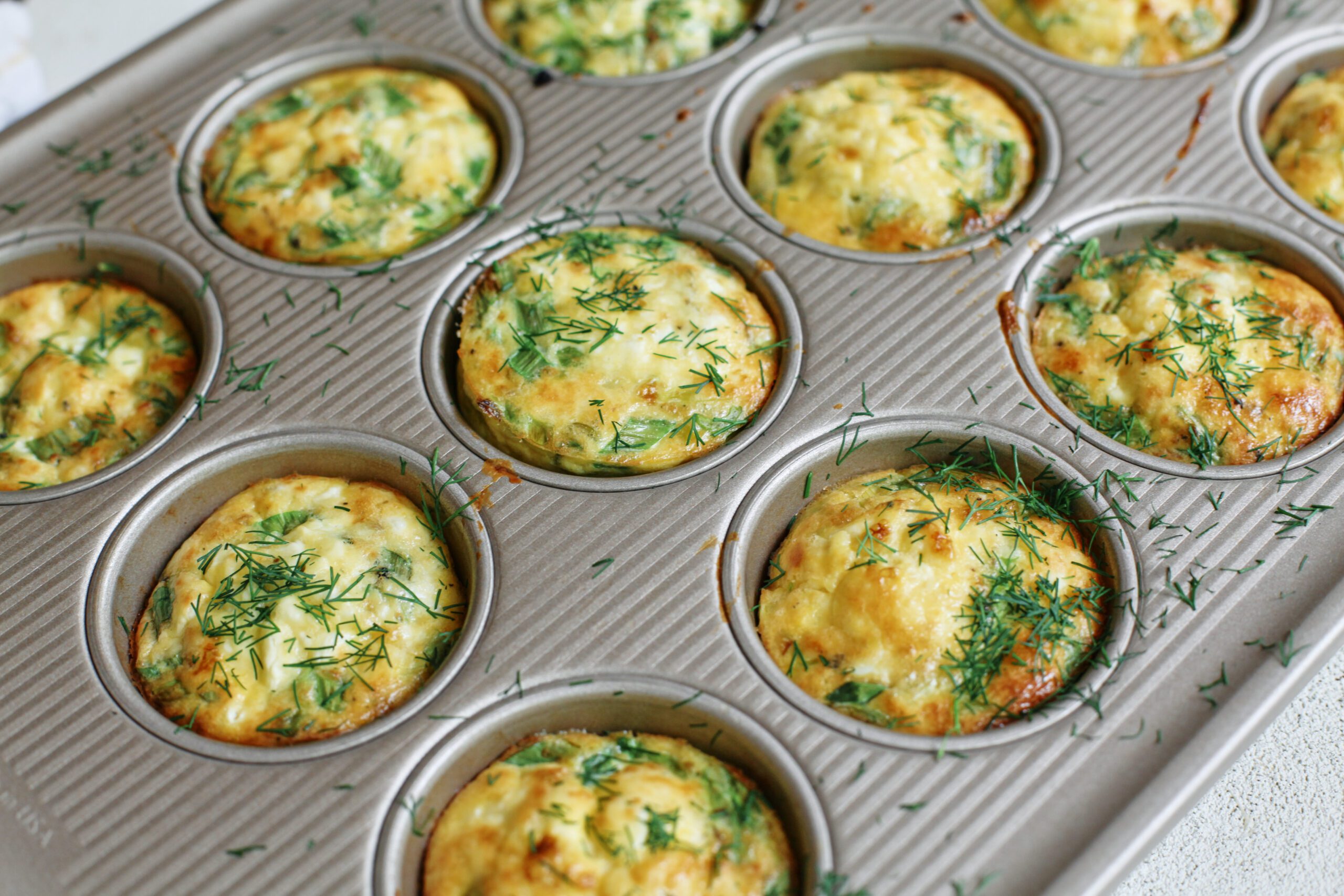 baked mini spring frittata bites, topped with fresh dill