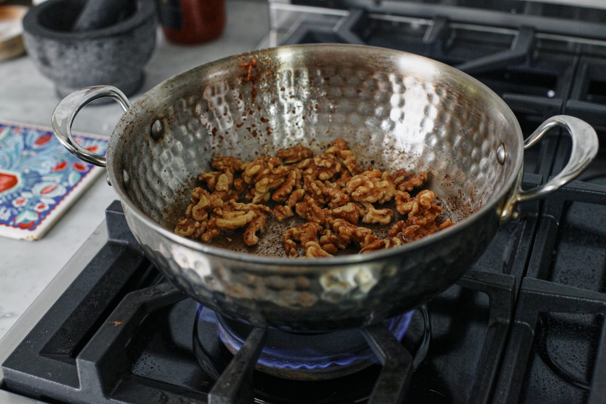 California walnuts toasting in a pan on the stove