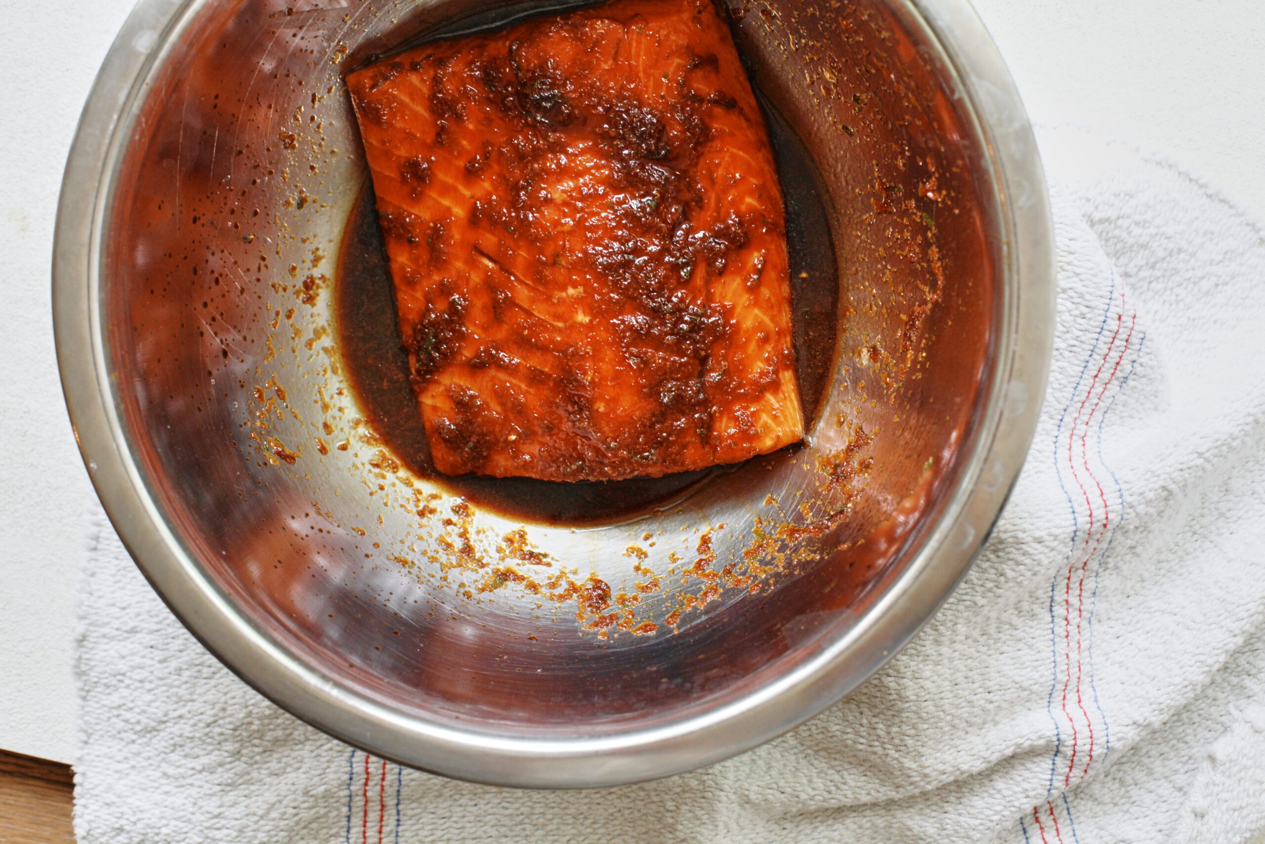 salmon marinating in a bowl
