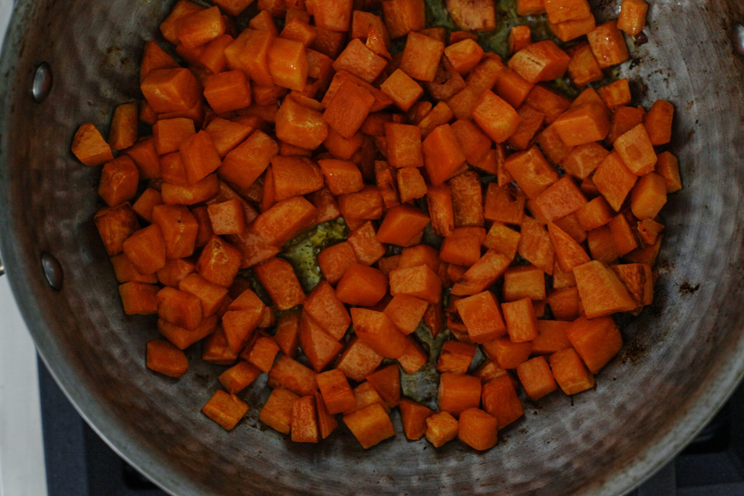 sweet potatoes sautéing in a pan