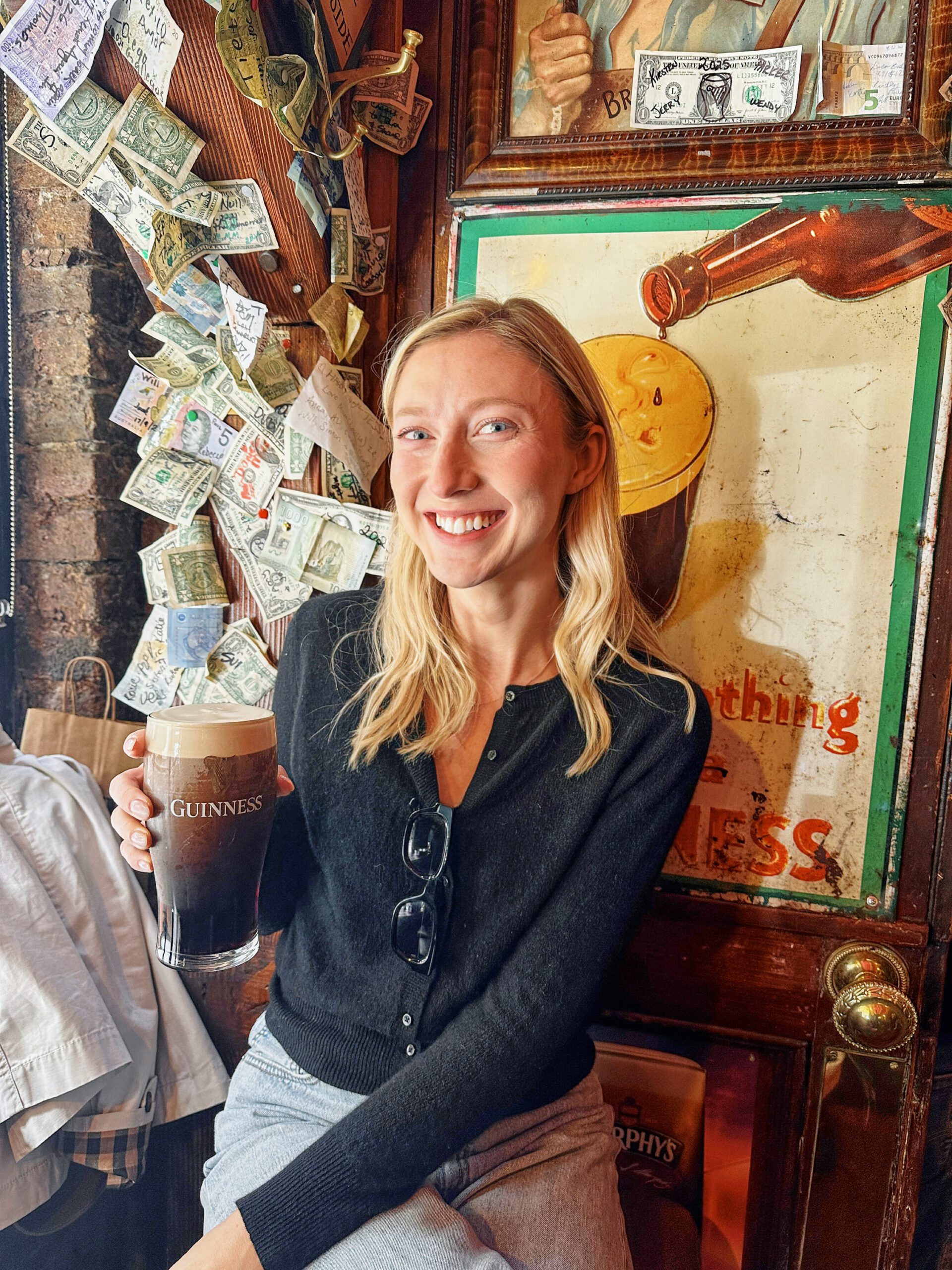 me (Brita) at The Hairy Lemon pub holding a pint of Guinness