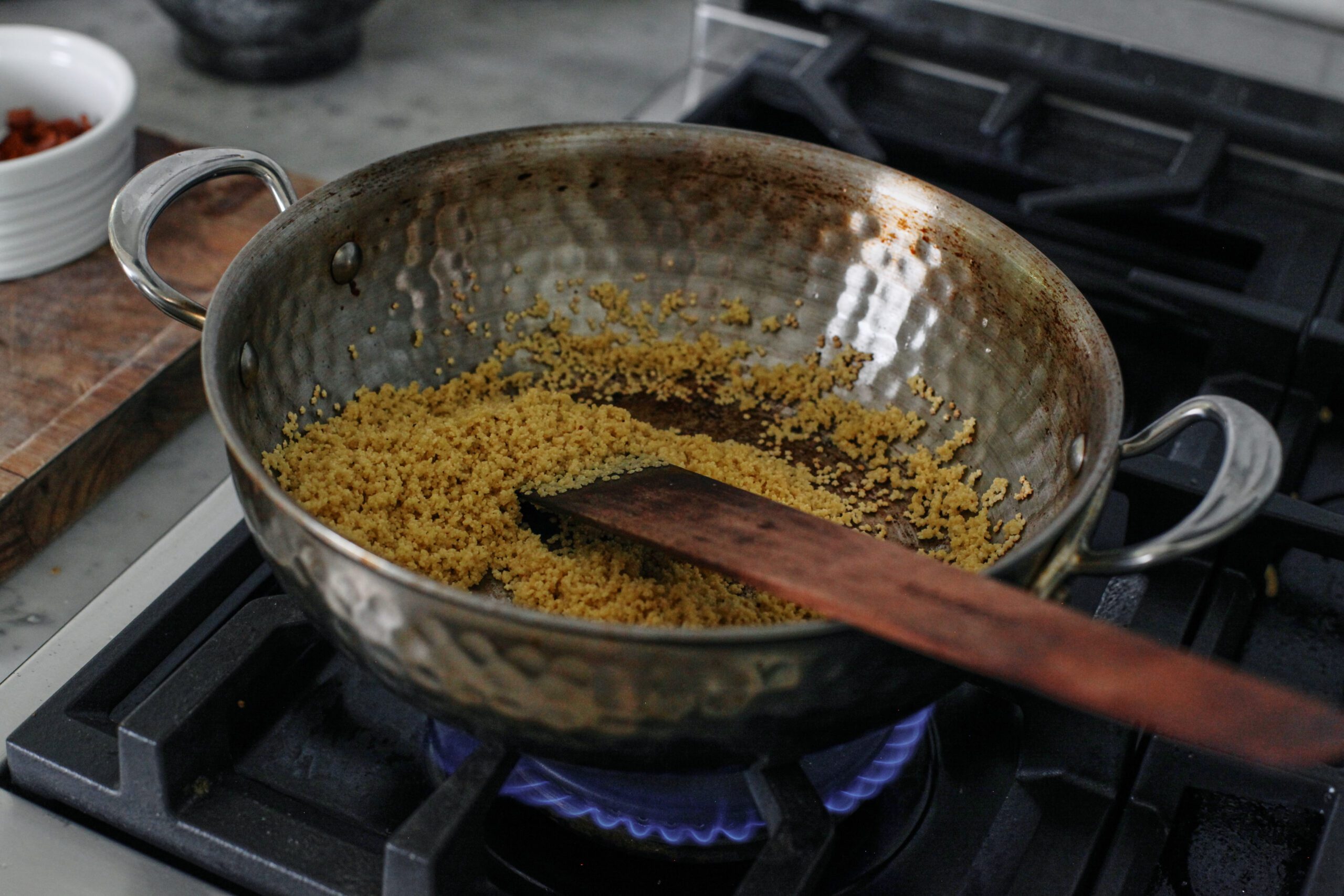 pastina toasting in a pan over the stove