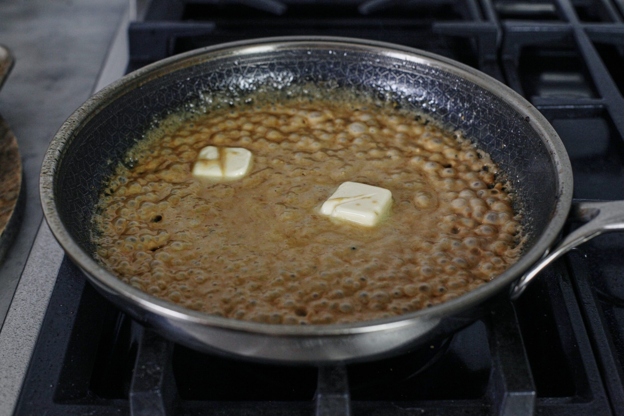 pan sauce coming together with stock, cream, butter