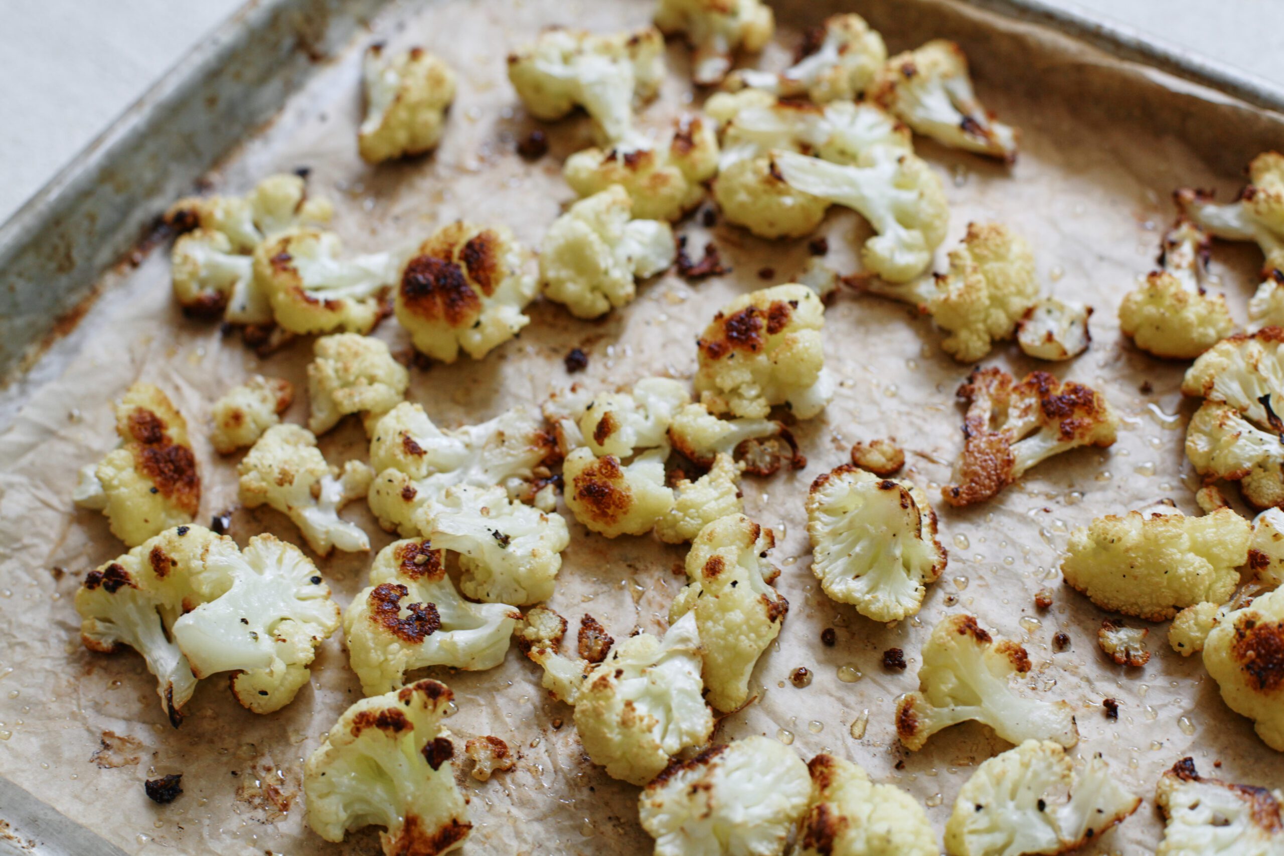 roasted cauliflower on a parchment lined pan