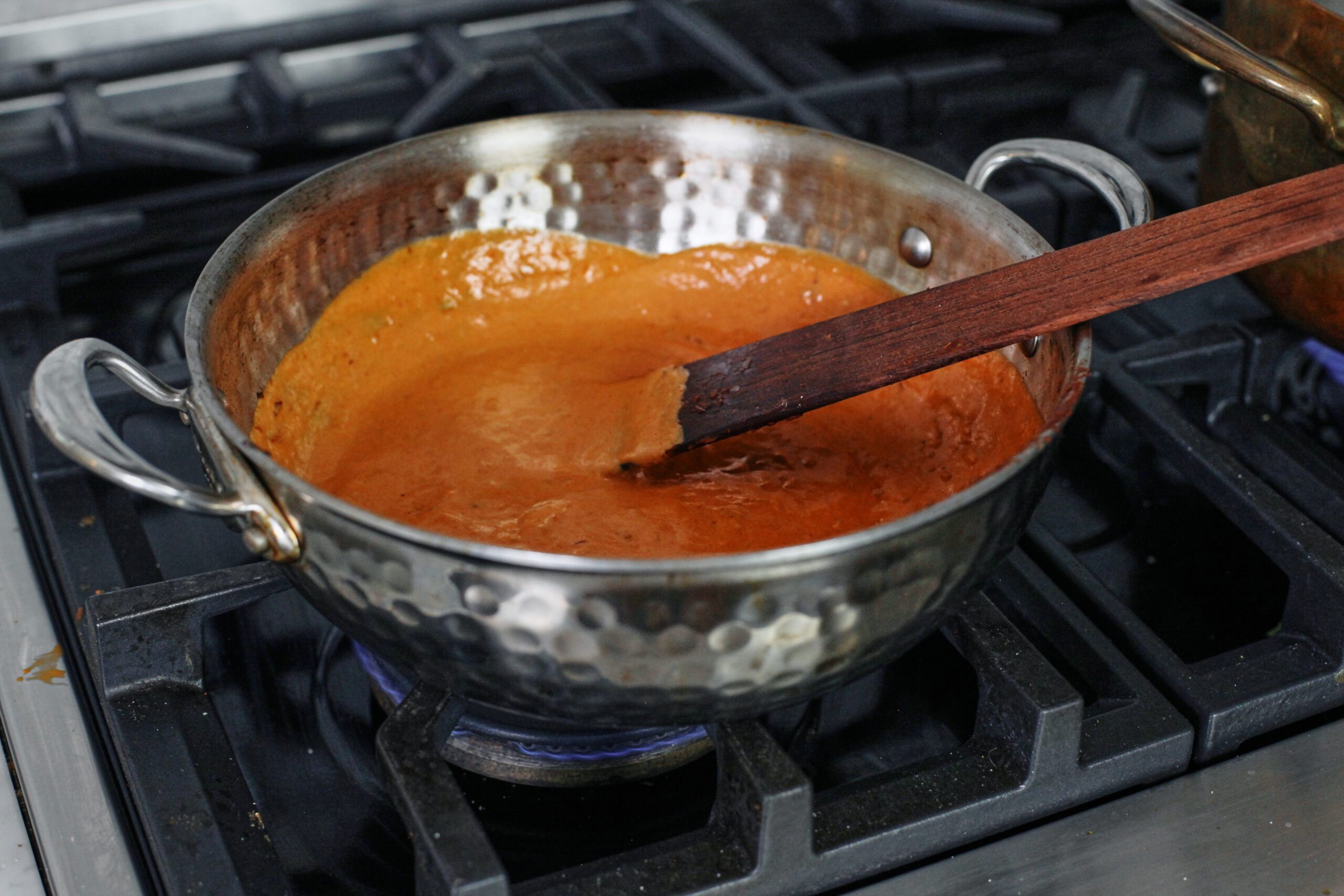 chili oil penne alla vodka 11 the vodka sauce being cooked in a pan after the heavy cream has been added