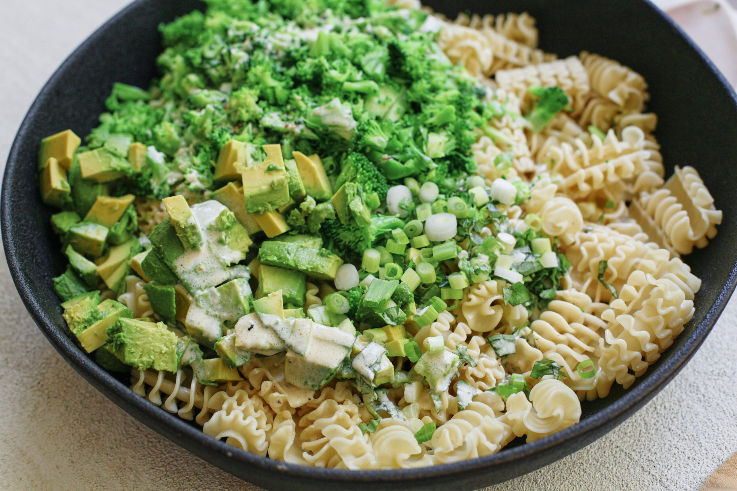 broccoli caesar pasta salad, before being mixed to combine