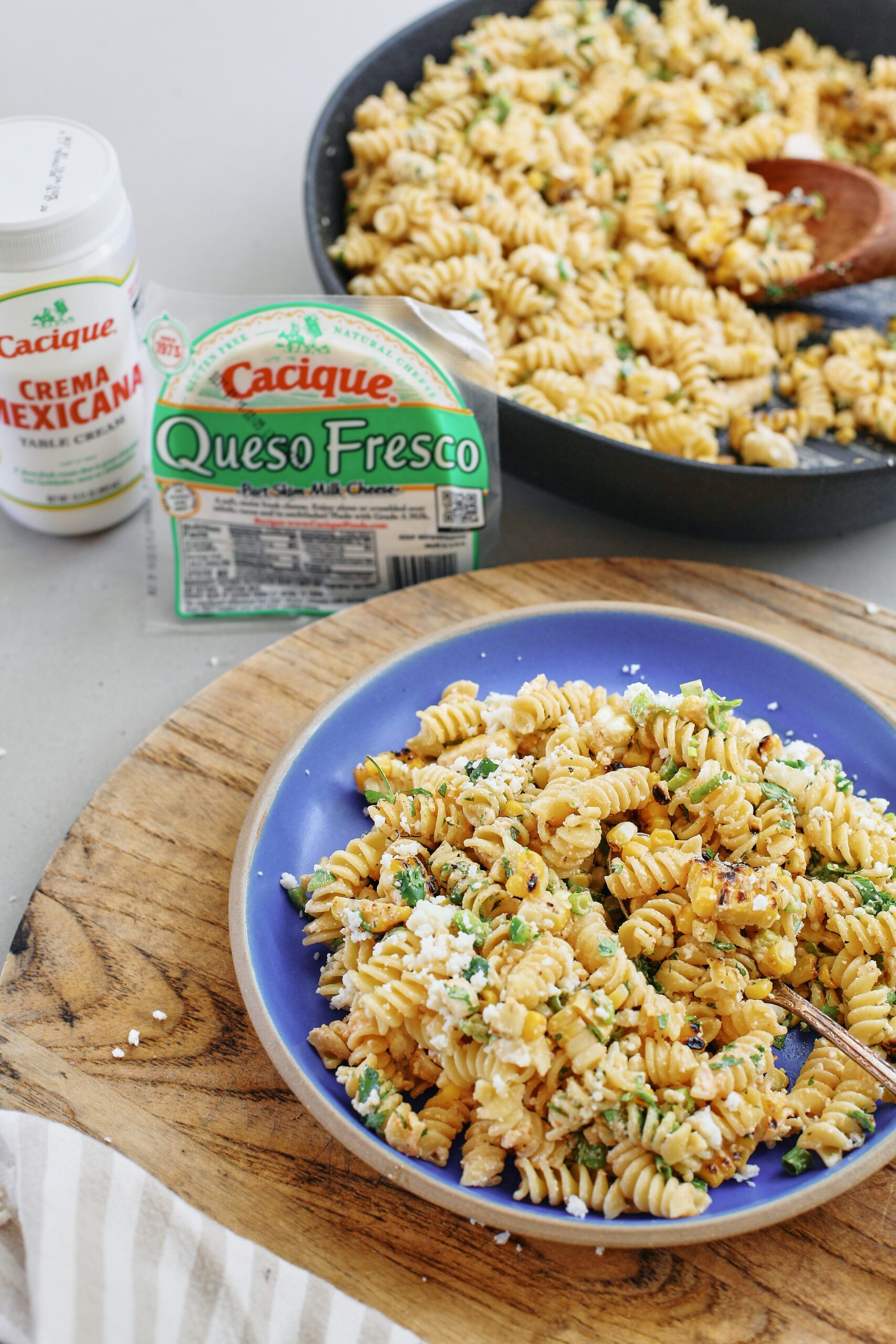 elote pasta salad served on a blue ceramic plate