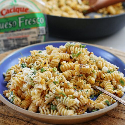 elote pasta salad on a cobalt blue ceramic plate