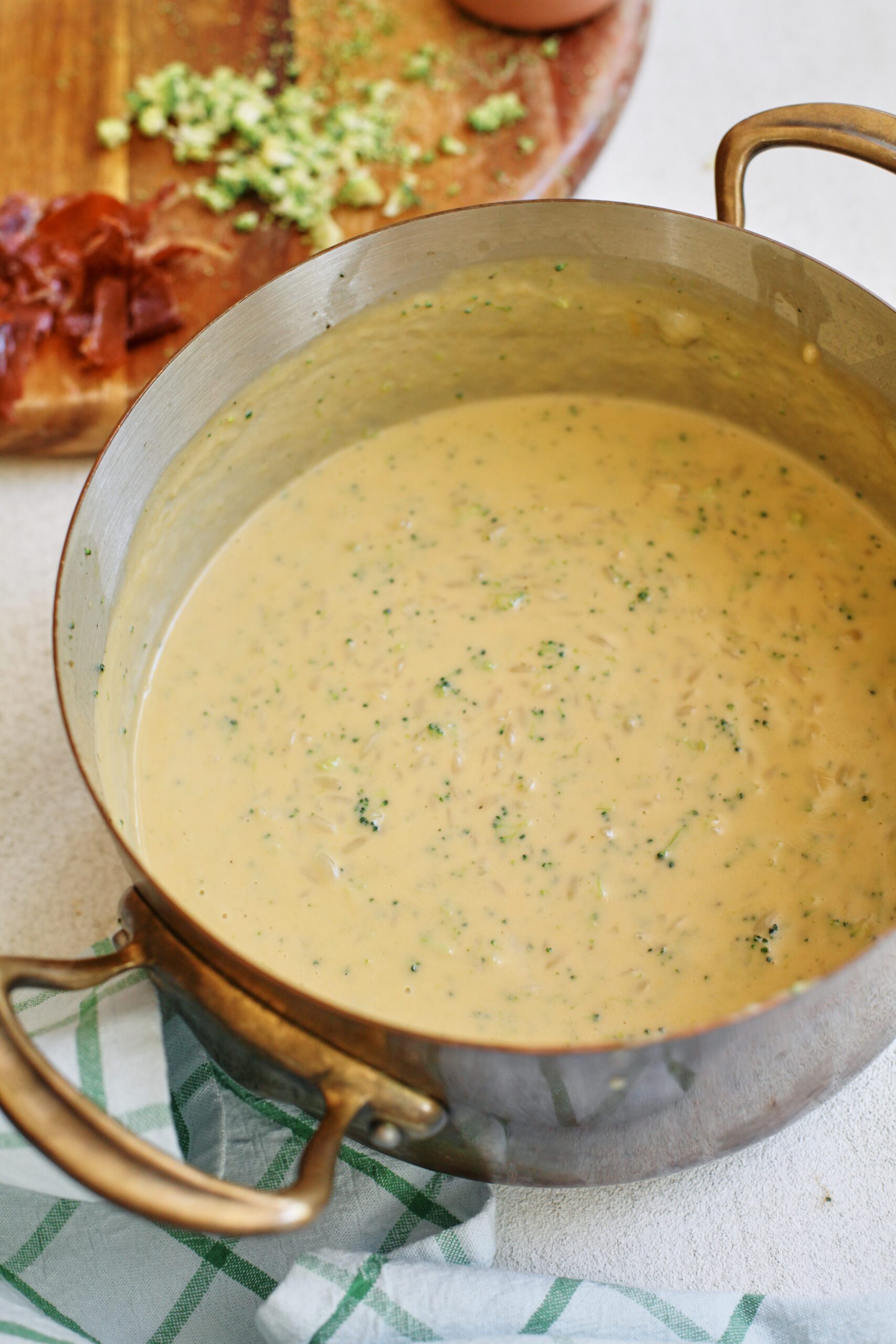 creamy broccoli cheddar orzo soup in the pot ready to be served