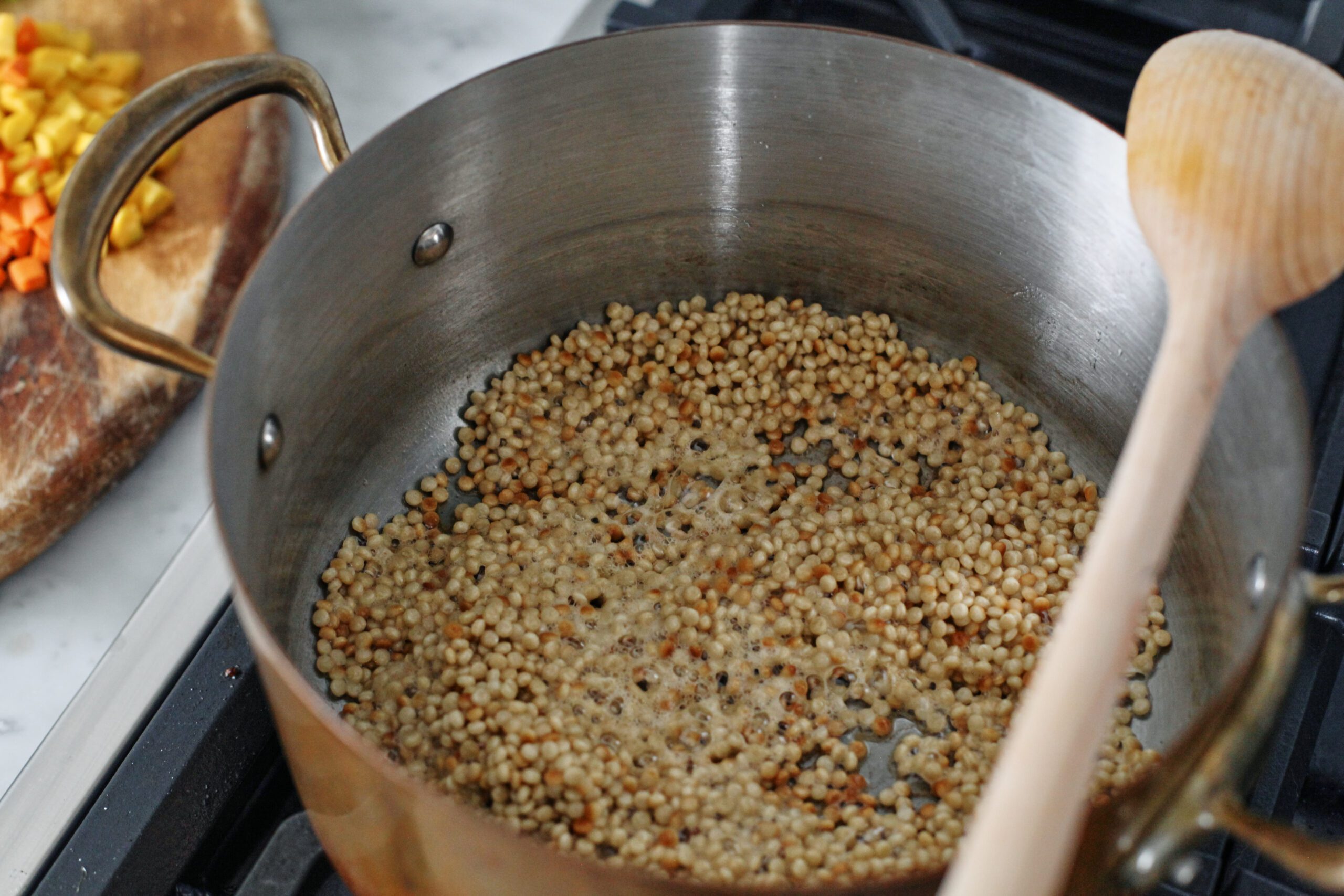 pearl couscous toasting in a pot