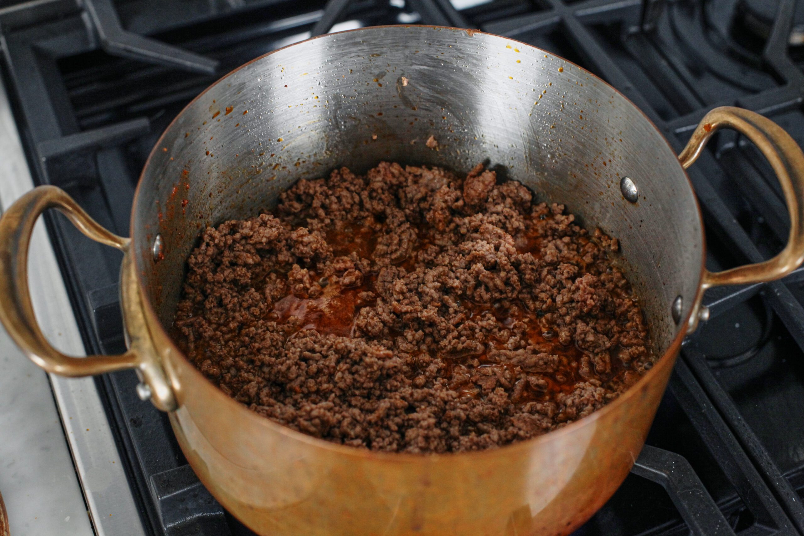 ground beef browning in a pot