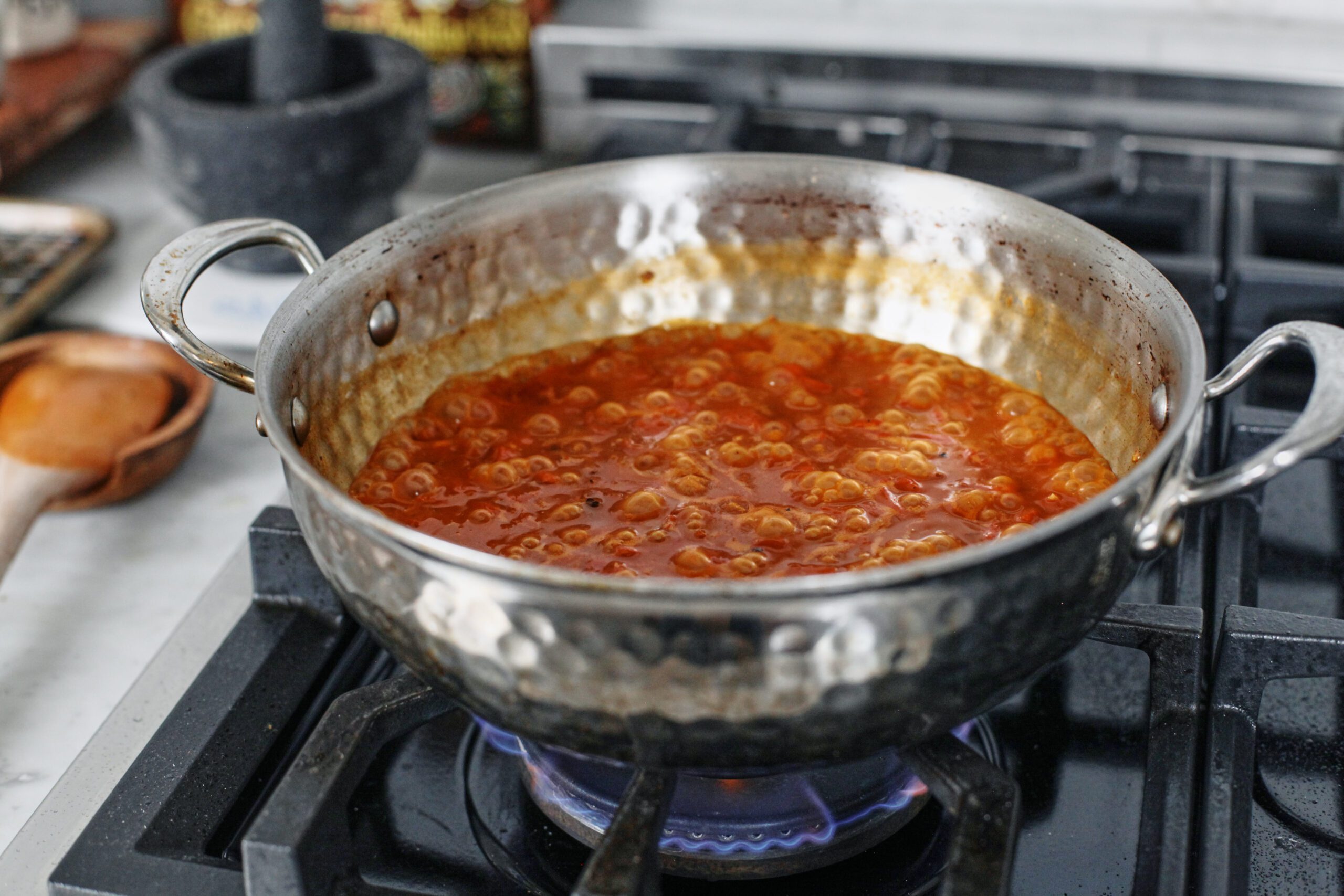 roasted red pepper orzo simmering in a large pan
