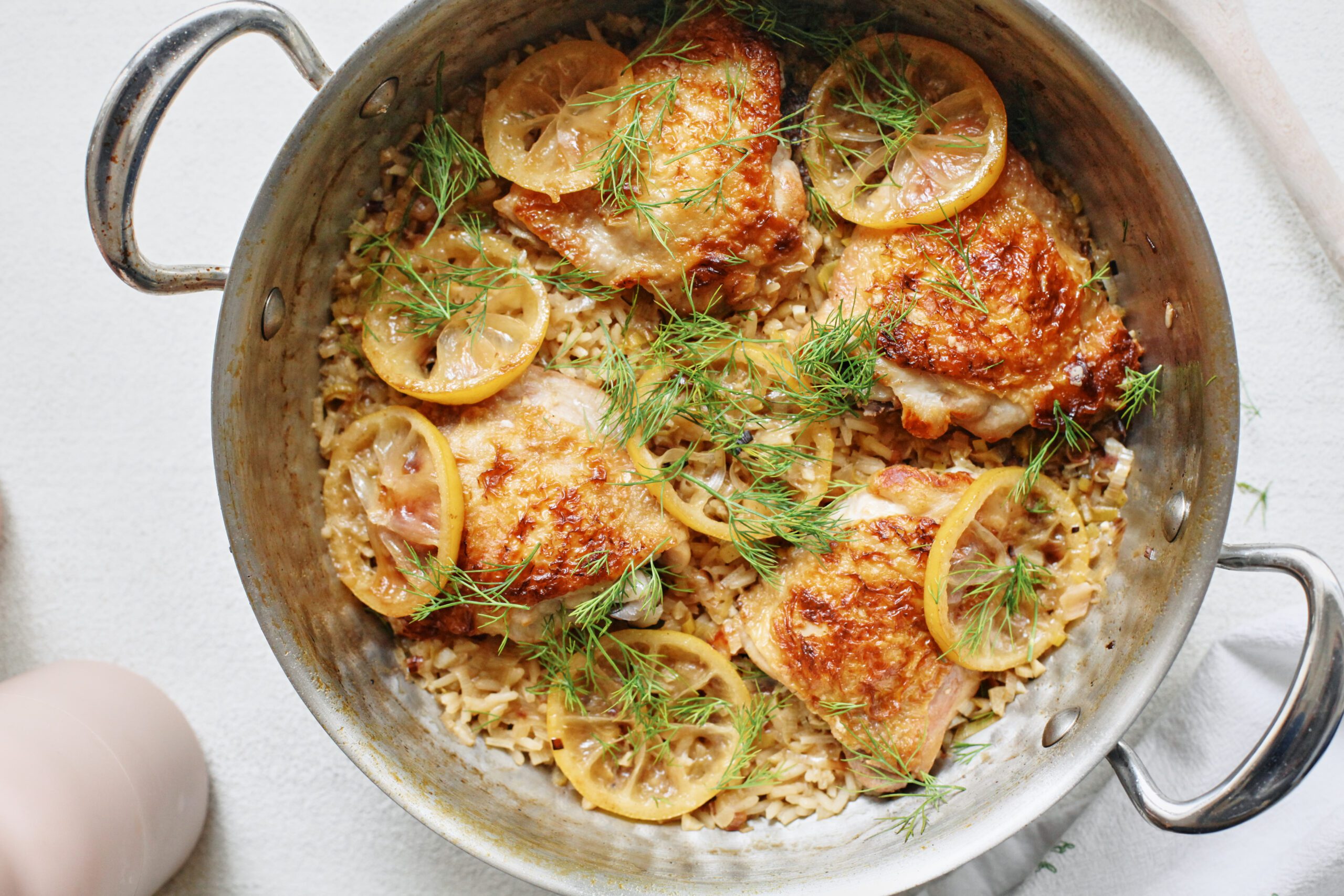 overhead photo of One Pot Lemony Dill Chicken and Rice in a deep hammered steel pan